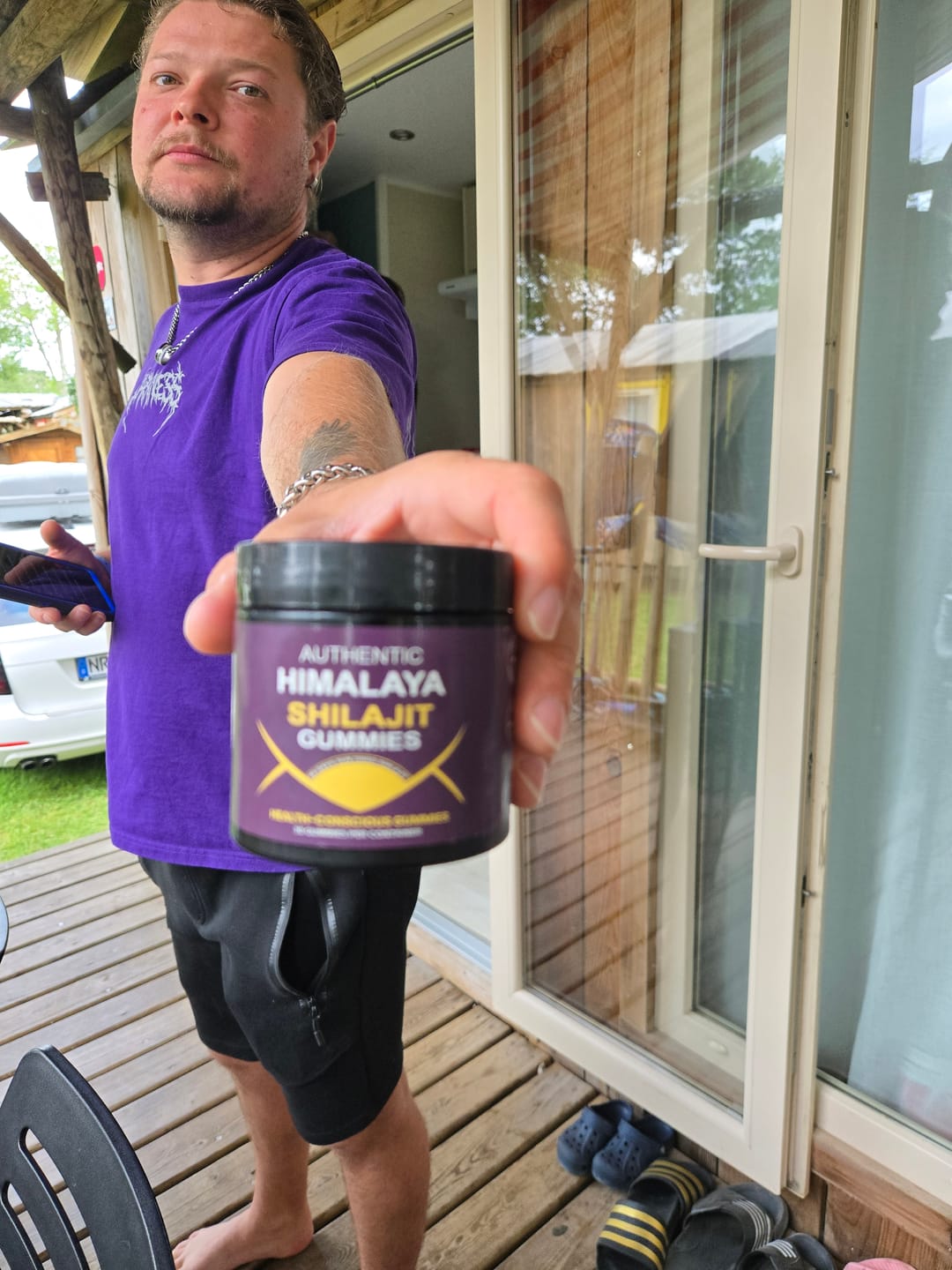 Person holding a bottle of shilajit gummies.